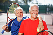 Older men smiling on tennis court