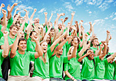 Crowd in green t-shirts cheering