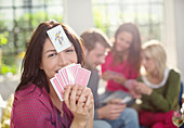 Smiling woman playing card game