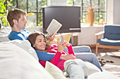 Couple relaxing on sofa together