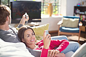 Couple relaxing on sofa together