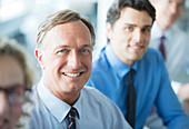 Businessmen smiling in meeting