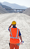 Worker standing on road in quarry