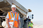 Businessman standing by truck on site