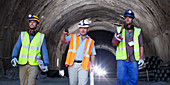Businessman and workers walking in tunnel