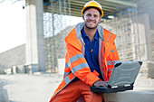 Worker using laptop on site