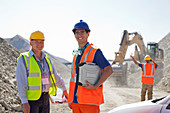 Worker and businessman standing in quarry