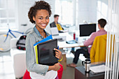 Businesswoman carrying laptop in office