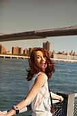 Smiling woman at urban waterfront