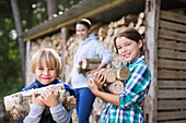 Children carrying firewood outdoors