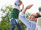 Father and son high fiving outdoors