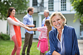 Smiling woman sitting outdoors