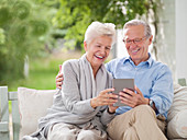 Couple using digital tablet