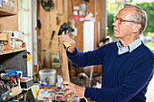 Man sanding wood in garage