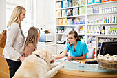 Receptionist greeting dog