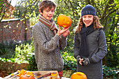 Children carving pumpkins together