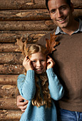 Girl using leaves as antlers