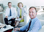 Business people smiling in office lobby