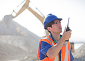 Worker using walkie-talkie in quarry