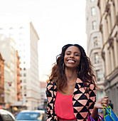 Smiling woman walking on city street