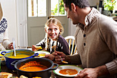 Father and daughter eating together