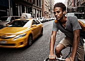 Man riding bicycle on city street