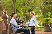 Father and son in urban park