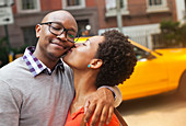 Couple kissing on city street