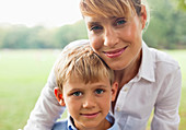 Smiling mother hugging son outdoors