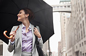 Businesswoman holding umbrella