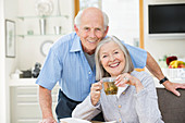 Older couple smiling in kitchen