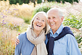 Older couple hugging outdoors