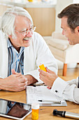 Doctor giving medication to older patient