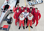 Racing team smiling at pit stop