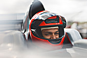 Racer sitting in car on track