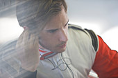 Racer listening to earphones indoors