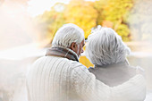 Older couple standing together in park