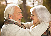 Older couple hugging outdoors