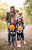Couple with children in skeleton costumes