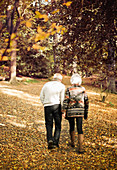 Older couple walking together in park