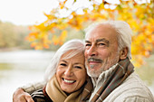 Older couple hugging in park