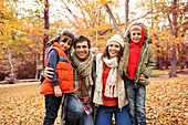 Family smiling together in park