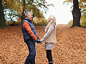 Older couple holding hands in park