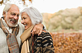 Older couple smiling together in park