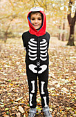 Boy wearing skeleton costume in park