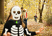 Children in skeleton costumes in park