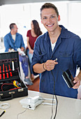 Electrician working on telephone in home