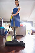 Woman vacuuming living room floor