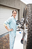 Woman working on bicycle in driveway