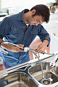 Plumber working on kitchen sink